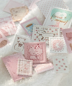 Macro detail of retro letterpress stamp stickers with cats and coffee patterns on soft fur
