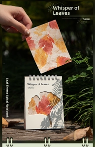 Detail of leaf-themed spiral notebook featuring a ginkgo leaf cutout on textured cover