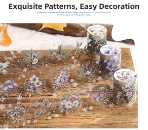 Detailed view of floral and snowflake PET tapes on a rustic wooden background with snow