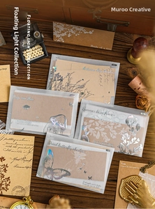 Detail of vintage scrapbooking material set with translucent envelopes and floral cards