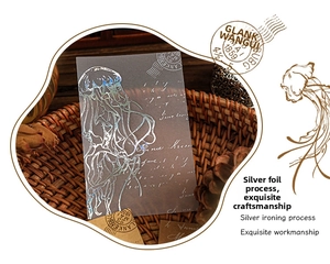 Macro shot of silver jellyfish stickers with foil stamping on vintage brown background