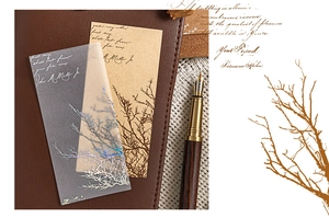 Macro shot of vintage style stickers with branch patterns and cursive text on paper
