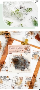 Close-up of Shadow Trace vintage PET stickers with green botanical and stamp designs
