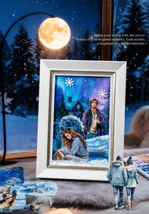 Macro detail of DIY winter wonderland 3D sticker art set with snowy cabin and couple