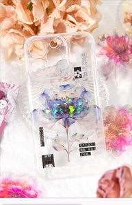 Detailed close-up of transparent iPhone case with holographic floral patterns and poetry