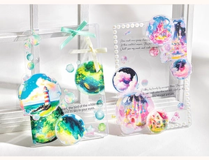 Detail view of decorative acrylic card holders with lighthouse and castle motifs