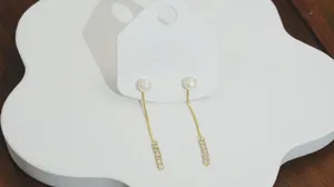 Detail of S925 sterling silver long fringe earrings with white round pearls and crystals