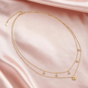 Détail du poinçon S925 sur collier trèfle à double épaisseur avec perles et plaqué or