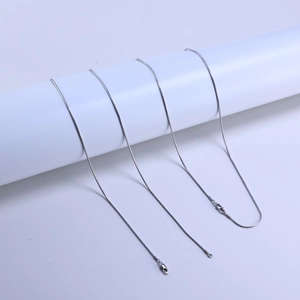 Detailed view of 925 silver snake chains with durable lobster clasp closures on a stand