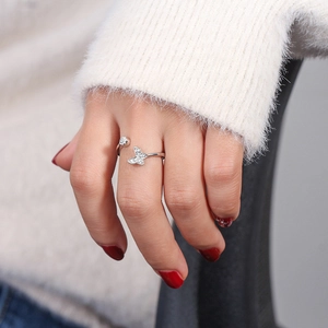 Macro shot of a silver butterfly open ring with sparkling pavé crystals and side stone