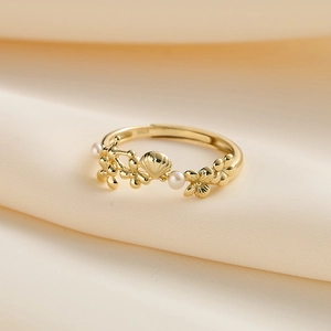 Macro shot of S925 silver gold-plated ring with pearl shell and flower details