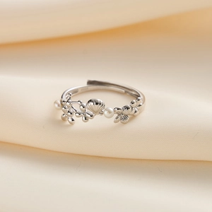 Macro shot of S925 silver ring featuring floral shell motifs and white pearl details
