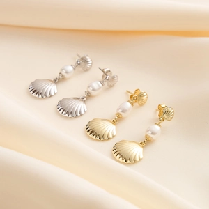 Elegant shell-shaped S925 silver earrings with natural pearls on silk fabric
