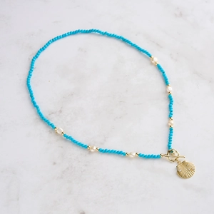 Detail of S925 silver ocean style necklace with blue beads, pearls and shell pendant