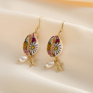 Bohemian gold daisy seashell earrings with starfish and pearl drops on silk background