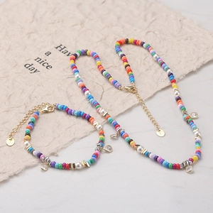 Colorful bead and pearl necklace and bracelet set with S925 silver clasp on textured paper