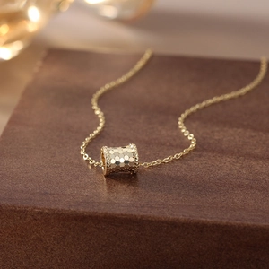 Macro view of golden honeycomb cylinder pendant on a classic silver cross chain link