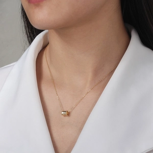 Elegant S925 sterling silver gold cylinder pendant necklace worn on a woman's collarbone