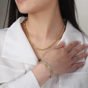 Close-up of a s925 silver gold necklace and bicolor bracelet with textured metal beads