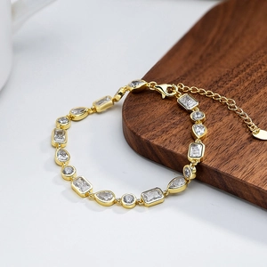 Detail of gold-plated bracelet featuring mixed-cut clear zircons and adjustable lobster clasp