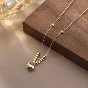 Polished gold heart pendant necklace with bead details on minimalist S925 silver chain