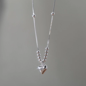Detailed view of S925 silver heart necklace with beads and shiny box chain link