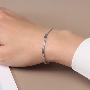 Elegant S925 sterling silver woven mesh bracelet on woman's wrist in minimalist style