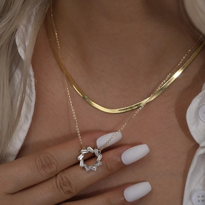 Elegant gold double-layered necklace set with round zircon pendant on a snake chain
