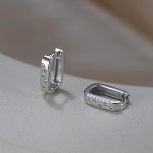 Detail shot of silver S925 square hoop earrings with micro-set cubic zirconia accents