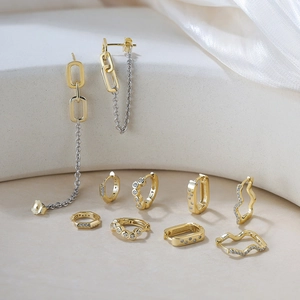 Macro detail of S925 sterling silver stamp on minimalist gold-plated hoop earrings