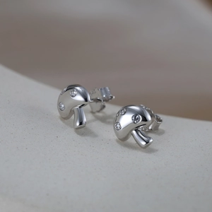 Macro shot of 925 silver mushroom stud earrings with sparkling cubic zirconia inlay