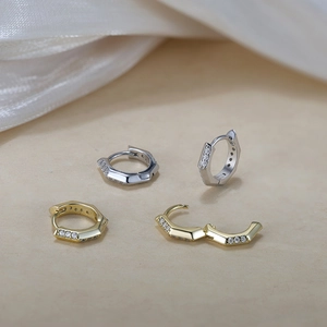 Detailed close-up of S925 silver hexagonal huggie earrings with gold and silver zircon inlay