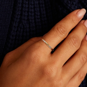 Detailed view of a slender S925 silver ring with diamonds on a gold-plated finish