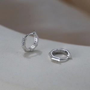 Detailed close-up of S925 sterling silver hexagonal hoop earrings with zircon stones