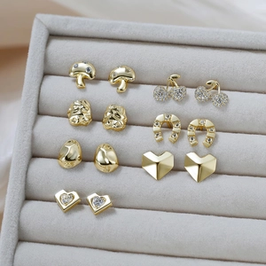 Detail of 6 pairs of gold S925 sterling silver earrings set in a grey velvet jewelry box