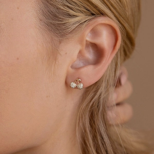 Sparkling S925 silver cherry stud earrings with pavé crystals on elegant female model