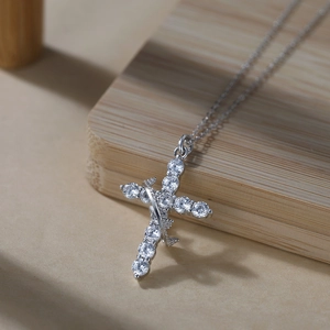 Macro shot of silver crown cross necklace pendant with sparkling zircon stones