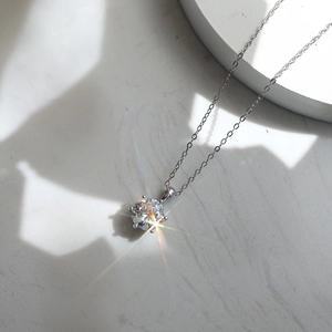 Classic S925 silver necklace with sparkling six-prong round zircon pendant on marble