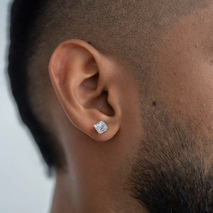 Macro shot of square step-cut zircon earring on male model showing detail and scale