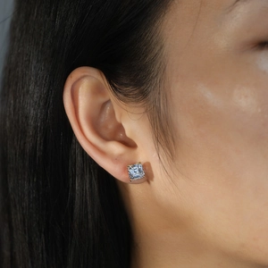 Detailed close-up of S925 silver square-cut zircon stud earring on female ear