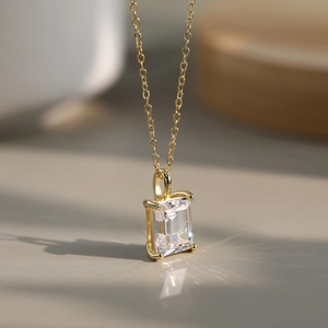 Macro detail of S925 silver gold necklace with emerald cut cubic zirconia pendant