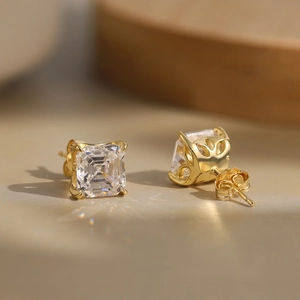 Macro shot of Princess cut square zircon earrings with gold plating and petal-carved details