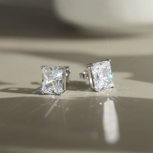 Close-up of square-cut sparkling zircon stud earrings in 925 silver with 4-prong setting