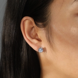 Macro shot of a classic six-prong 925 silver stud earring with a brilliant round zircon
