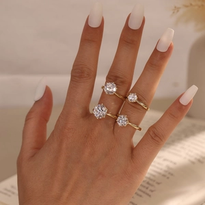 Set of four gold-plated S925 silver rings featuring round brilliant moissanite stones