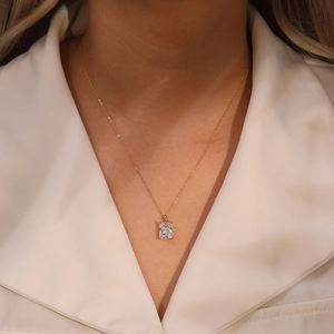 Close-up of elegant square zircon pendant necklace on gold chain for women