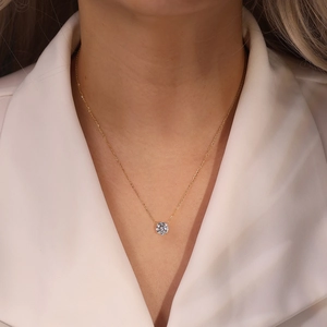 Close-up of S925 sterling silver necklace with a four-prong set sparkling round solitaire