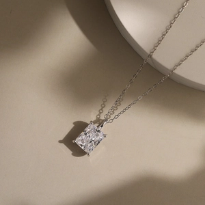 Macro detail of silver necklace featuring radiant cut zircon in a four-prong setting