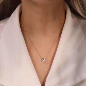 Detail of a minimalist gold S925 sterling silver necklace with a sparkling round zircon