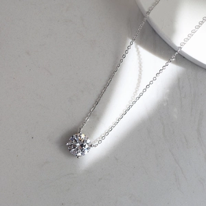 Macro shot of a brilliant round cut solitaire diamond pendant on a S925 silver chain